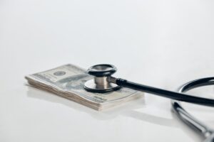 stethoscope on a pile of money 