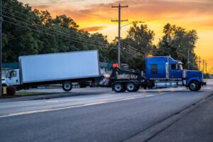 Truck being towed from an accident. Learn what happens when a truck driver has an accident