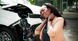 A woman after a car accident. You can learn what to do if you got in an accident with an uninsured driver from an lawyer. 