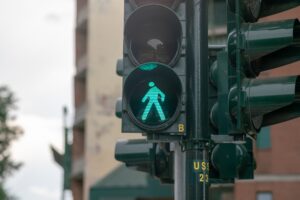 A pedestrian walk sign lights up green at an intersection.