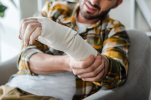 A man with a bandaged arm wonders, “Who is responsible in dog bite cases?”