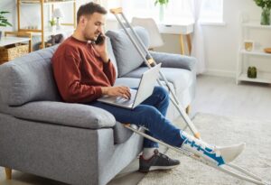 An injured motorcyclist recovering with a broken leg consults a motorcycle accident lawyer about pursuing damages after a crash.