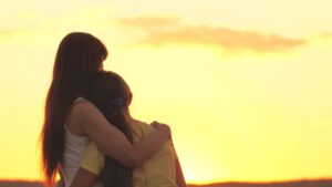 A grieving mother embracing her child and wondering if wrongful death is a personal injury.